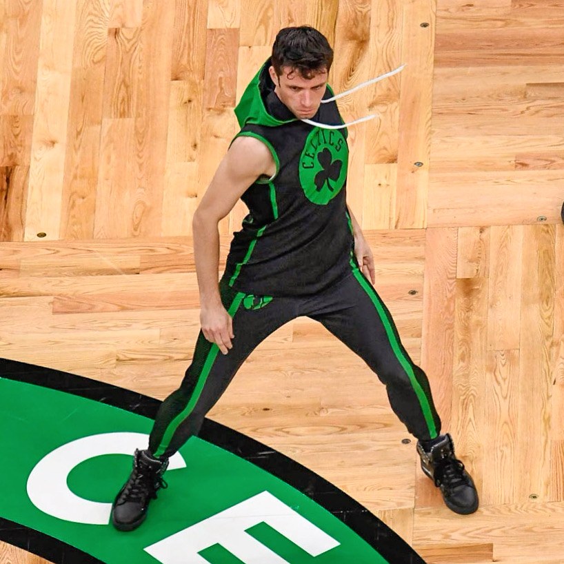 Pat Planet dancing on the Boston Celtics court in a black and green Celtics outfit